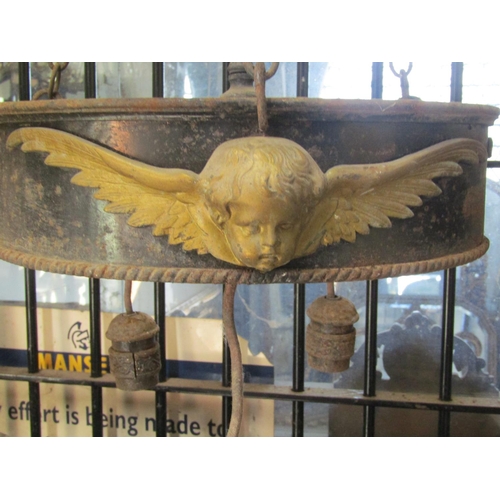 2120 - A run of four large iron work ceiling light fittings with gilt painted highlighted winged cherub det... 