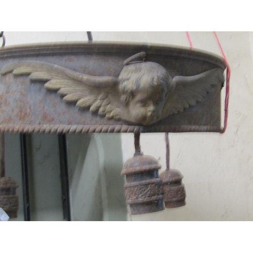 2120 - A run of four large iron work ceiling light fittings with gilt painted highlighted winged cherub det... 