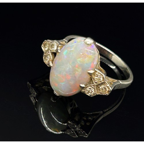 1377 - An antique platinum, opal and diamond dress ring, the central opal flanked with diamond-set shoulder... 