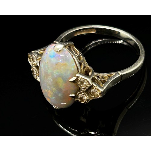 1377 - An antique platinum, opal and diamond dress ring, the central opal flanked with diamond-set shoulder... 