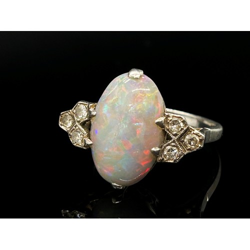 1377 - An antique platinum, opal and diamond dress ring, the central opal flanked with diamond-set shoulder... 