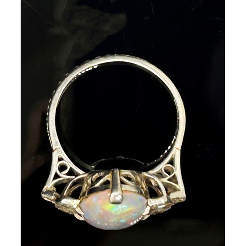 1377 - An antique platinum, opal and diamond dress ring, the central opal flanked with diamond-set shoulder... 