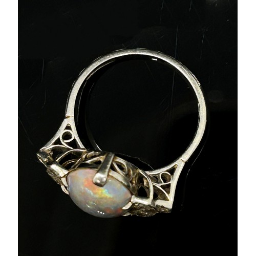 1377 - An antique platinum, opal and diamond dress ring, the central opal flanked with diamond-set shoulder... 