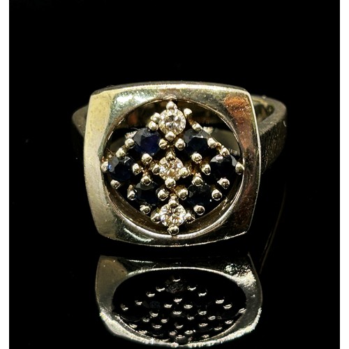 1376 - An unusual 18ct white gold, sapphire and diamond set dress ring, with openwork mount, size N/O, 10g