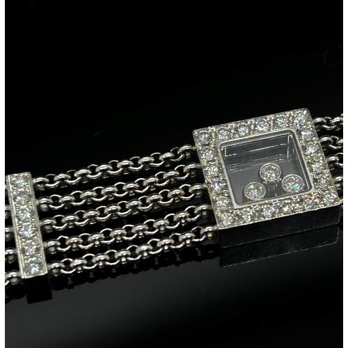 1369 - Chopard. An 18ct white gold ‘Happy Diamonds’ bracelet, on a five strand chain bracelet spaced with d... 