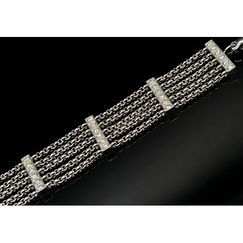 1369 - Chopard. An 18ct white gold ‘Happy Diamonds’ bracelet, on a five strand chain bracelet spaced with d... 