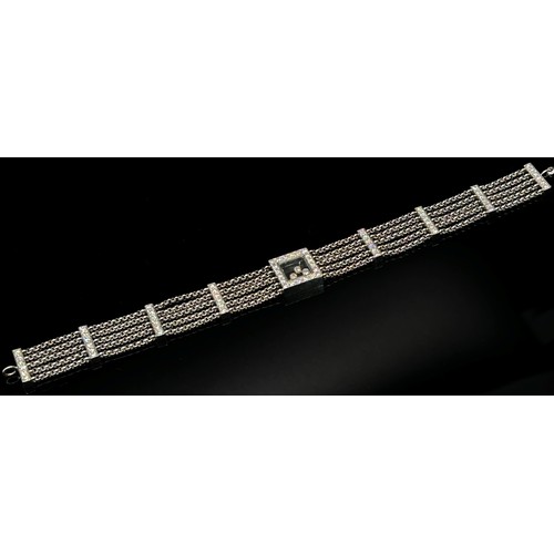 1369 - Chopard. An 18ct white gold ‘Happy Diamonds’ bracelet, on a five strand chain bracelet spaced with d... 