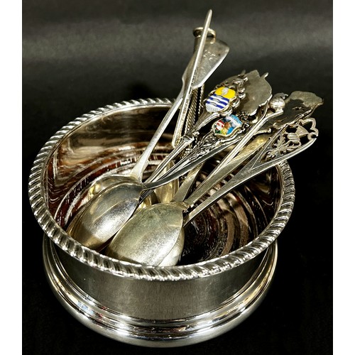 243 - Nine assorted silver souvenir spoons, a silver wine coaster and a pencil casing