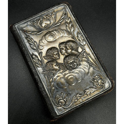 252 - An English Common Prayer Book with a silver mounted front cover of angels amongst clouds