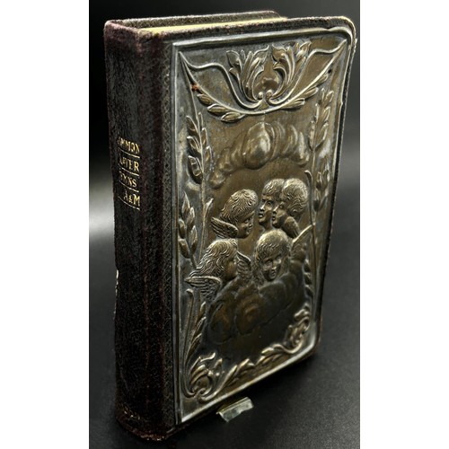 252 - An English Common Prayer Book with a silver mounted front cover of angels amongst clouds