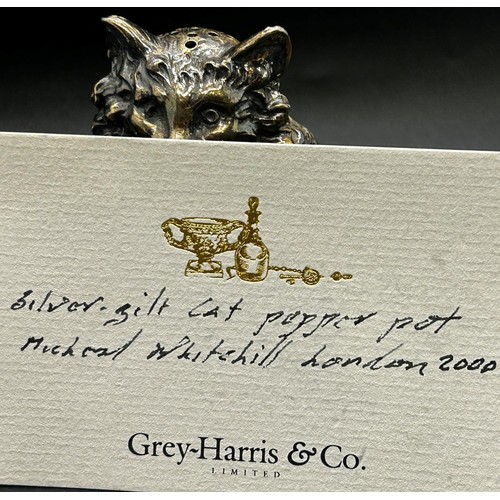 254 - A silver gilt cat pepper pot by Michael Whitehill, London 2000, retailed by Grey-Harris & Co, Clifto... 