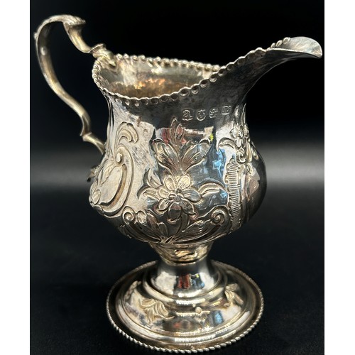 260 - A George III milk jug with floral engraved decoration London 1776, maker Thomas Streetin, 9cm high 2... 