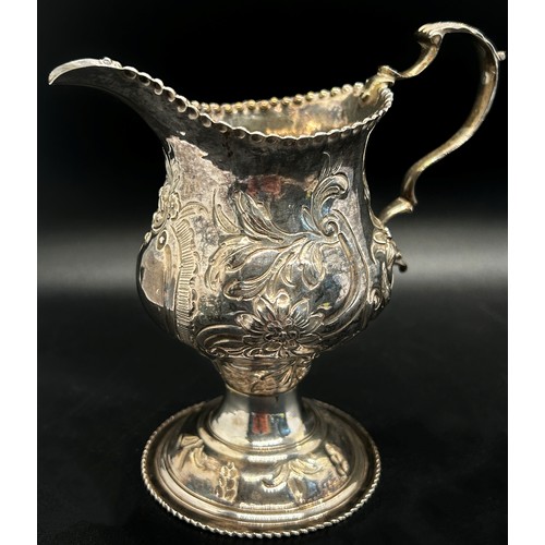 260 - A George III milk jug with floral engraved decoration London 1776, maker Thomas Streetin, 9cm high 2... 