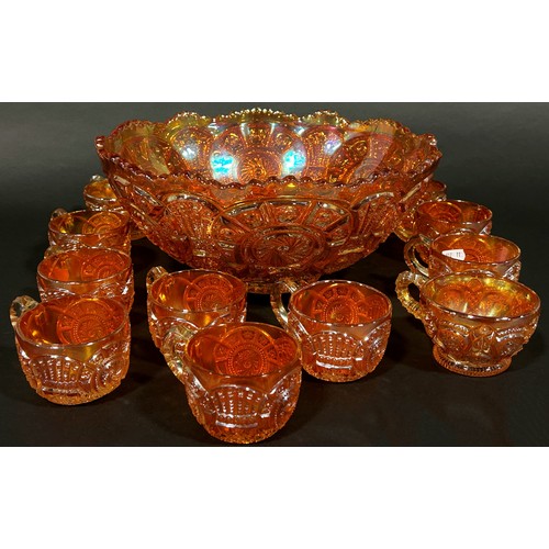 186 - A Carnival Tangerine Glass punch bowl and eleven cups together with a jug, bowl and vase.