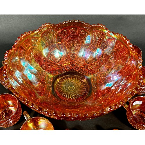 186 - A Carnival Tangerine Glass punch bowl and eleven cups together with a jug, bowl and vase.