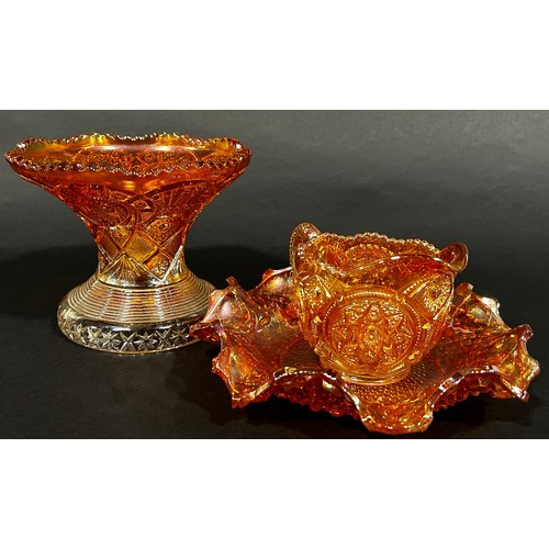 186 - A Carnival Tangerine Glass punch bowl and eleven cups together with a jug, bowl and vase.