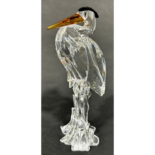 163 - Two Swarovski crystal animals a giraffe and a Heron, a further group of Swarovski miniature pieces w... 