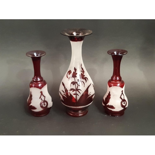 173 - A mixed selection of Cranberry and Bohemian red glassware including decanters, vases, a jug, and a l... 