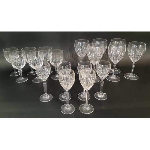 176 - A large suite of mixed cut glass wine glasses in varying styles and sizes