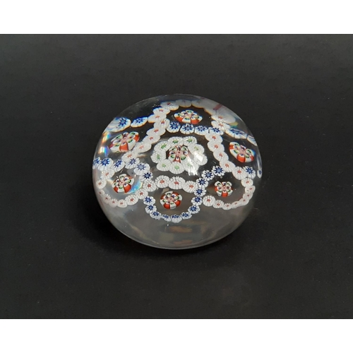 188 - A mid 19th century Baccarat clear glass millefiori paperweight with rings of coloured cane and facet... 