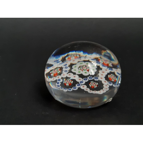 188 - A mid 19th century Baccarat clear glass millefiori paperweight with rings of coloured cane and facet... 