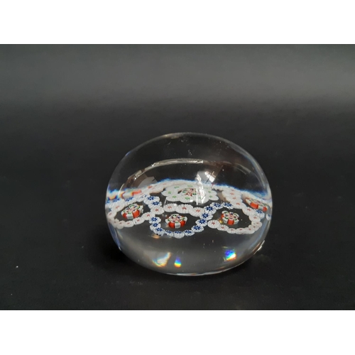 188 - A mid 19th century Baccarat clear glass millefiori paperweight with rings of coloured cane and facet... 