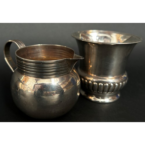 291 - A silver sugar bowl raised on three pad feet, a gadrooned beaker and a cream jug, 11 ozs approximate... 