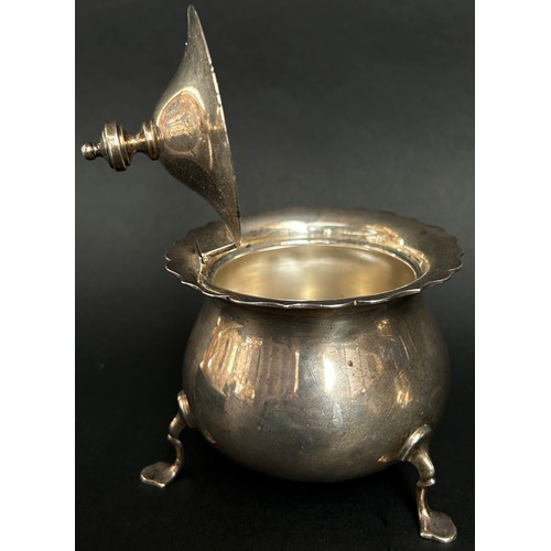 291 - A silver sugar bowl raised on three pad feet, a gadrooned beaker and a cream jug, 11 ozs approximate... 