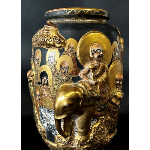 80 - A Japanese oviform vase richly decorated in relief with characters and elephants in procession, etc