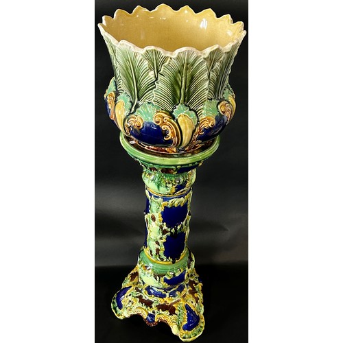 86 - A late 19th century majolica jardiniere and stand with scrolling acanthus and other detail