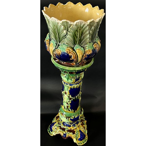 86 - A late 19th century majolica jardiniere and stand with scrolling acanthus and other detail