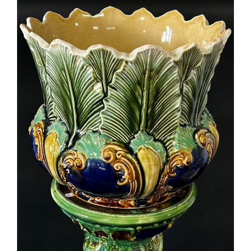 86 - A late 19th century majolica jardiniere and stand with scrolling acanthus and other detail