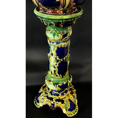 86 - A late 19th century majolica jardiniere and stand with scrolling acanthus and other detail