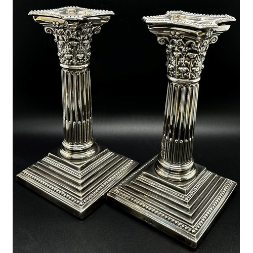 265 - A pair of silver Corinthian column candlesticks with removal sconces on square stepped bases, London... 