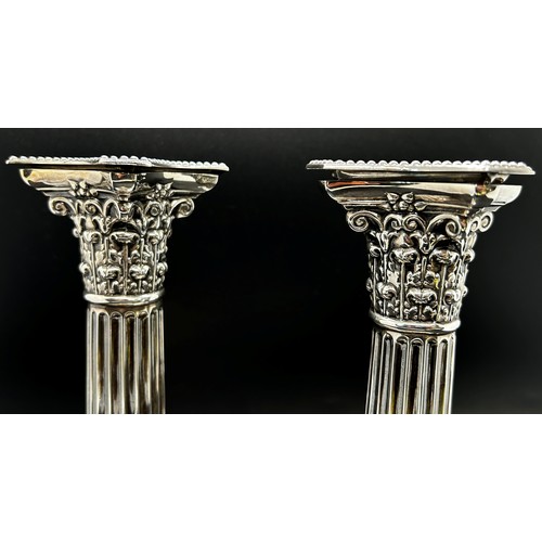 265 - A pair of silver Corinthian column candlesticks with removal sconces on square stepped bases, London... 