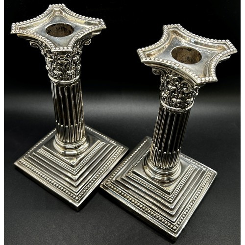 265 - A pair of silver Corinthian column candlesticks with removal sconces on square stepped bases, London... 