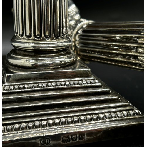 265 - A pair of silver Corinthian column candlesticks with removal sconces on square stepped bases, London... 