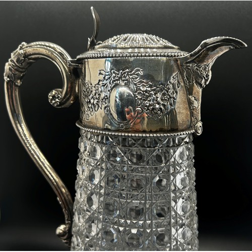 266 - A diamond cut glass claret jug with silver mounts and handle engraved with garlands, London 1896, ma... 