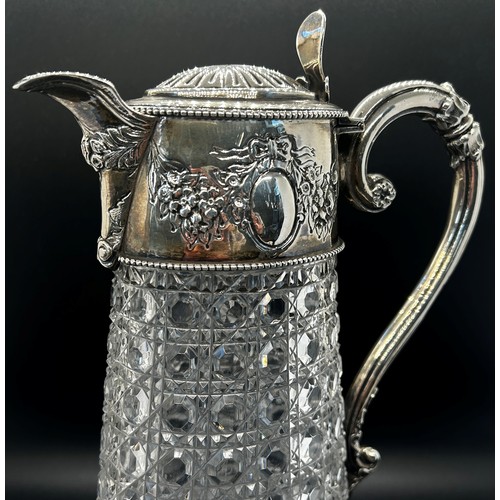 266 - A diamond cut glass claret jug with silver mounts and handle engraved with garlands, London 1896, ma... 