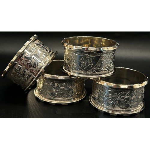 263 - A leather cased set of four matching silver napkin rings, late Victorian, Birmingham 1899, maker mak... 