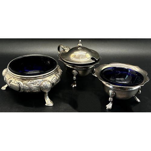 274 - A Victorian silver three legged salt cauldron with blue glass liner, a salt cauldron and mustard pot... 