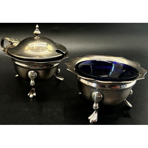 274 - A Victorian silver three legged salt cauldron with blue glass liner, a salt cauldron and mustard pot... 