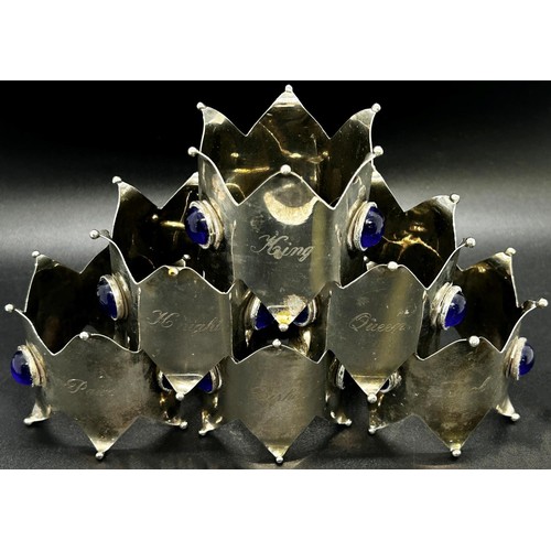 216 - A good selection of silver plate to include a set of six crown napkin rings set with blue cabochon s... 