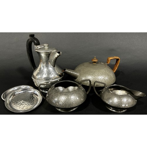 223 - A three piece Tudric Pewter tea service, teapot, sugar bowl and milk jug, all with a lightly hammere... 