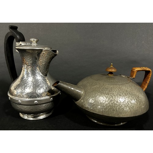 223 - A three piece Tudric Pewter tea service, teapot, sugar bowl and milk jug, all with a lightly hammere... 