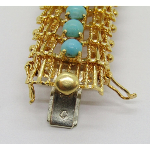 397 - Vintage foreign yellow metal bracelet set with a line of turquoise cabochons (one vacant), with twin... 