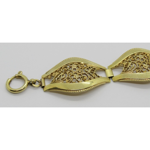 399 - Decorative yellow metal bracelet with floral openwork links, 20cm L approx, 21.8g