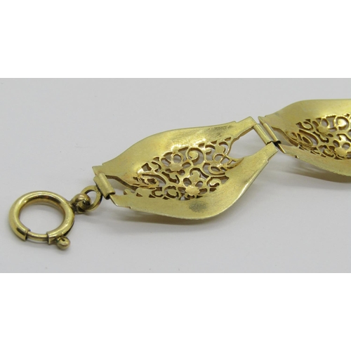 399 - Decorative yellow metal bracelet with floral openwork links, 20cm L approx, 21.8g