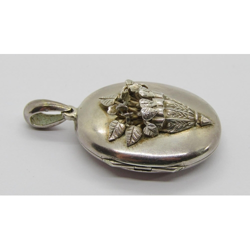 405 - Aesthetic Movement white metal locket decorated with a wall pocket of flowers in high relief, togeth... 