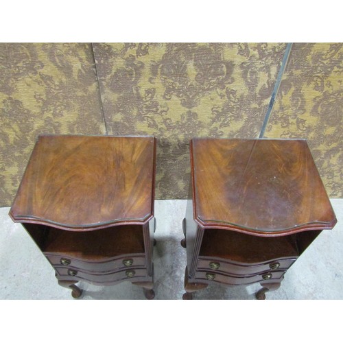 1122 - A pair of reproduction Georgian style bedside/lamp tables, the serpentine front partially enclosed b... 